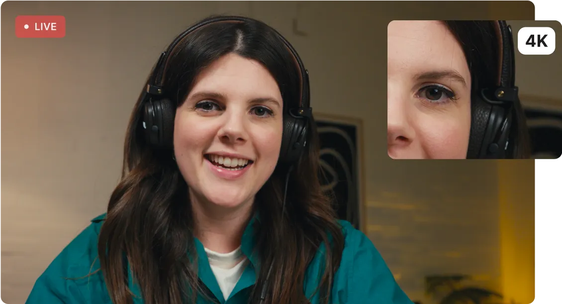 Smiling woman with long brown hair and headphones on a live 4K video call.